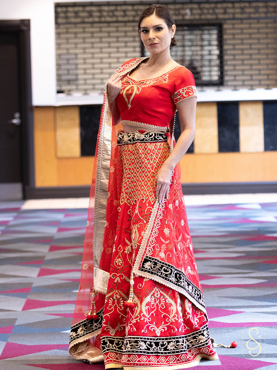 A woman in a fully zardozi embroidered lehenga set.