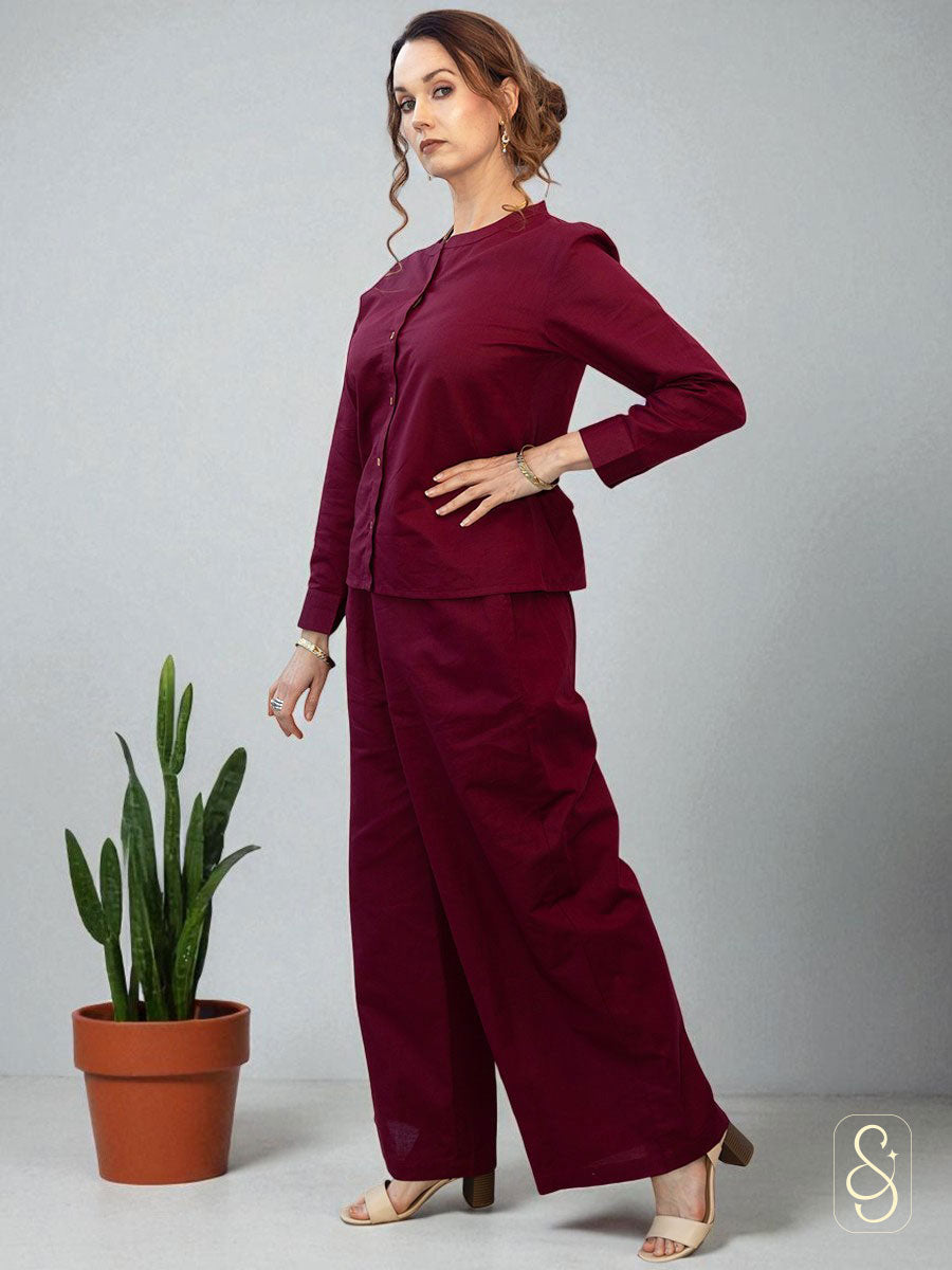 Side view of a woman wearing a solid maroon co-ord set.