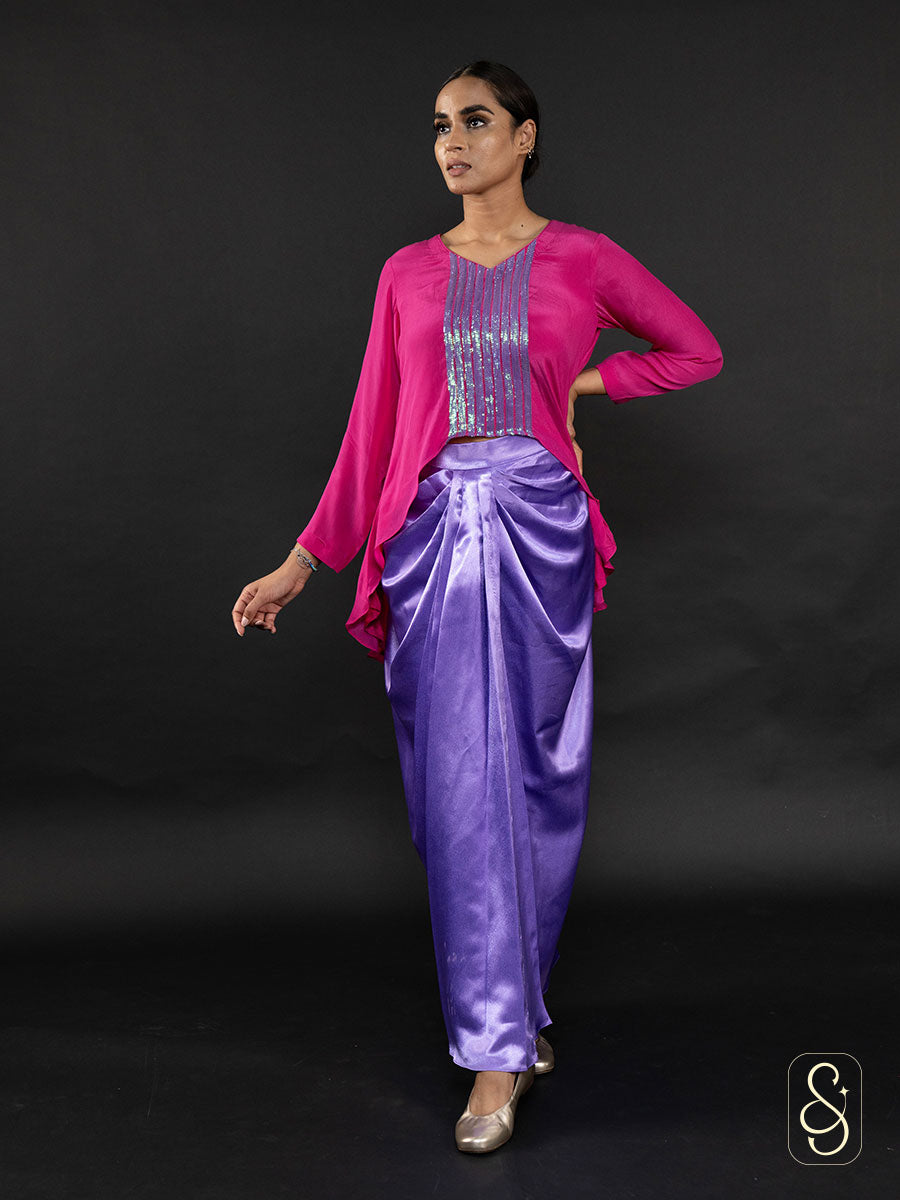 Woman wearing a satin skirt paired with a beautifully embroidered crepe top.