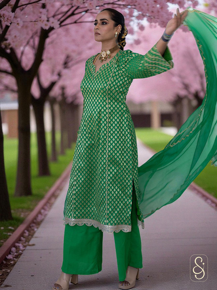 Woman in a green traditional outfit with a cherry blossom tree in the background