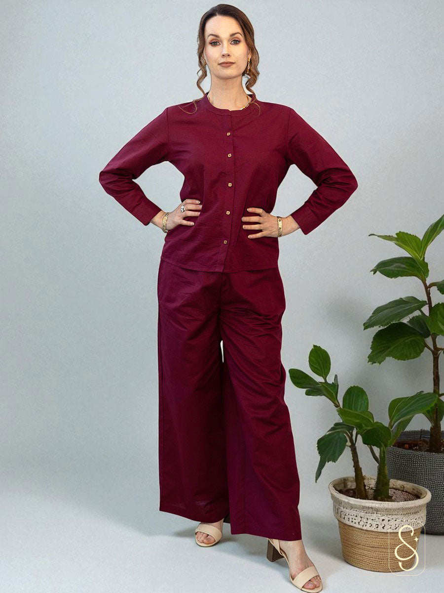 A woman posing by wearing a solid maroon full sleeve co-ord set.