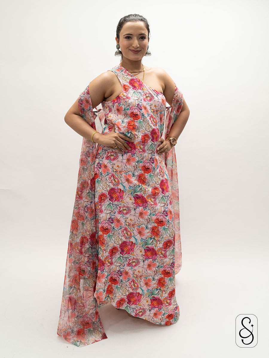 Woman wearing a floral satin one shoulder dress with organza jacket.