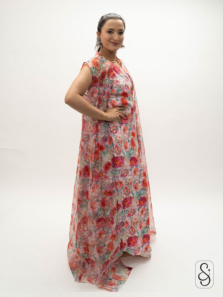 Woman wearing a floral satin one shoulder dress with organza jacket.