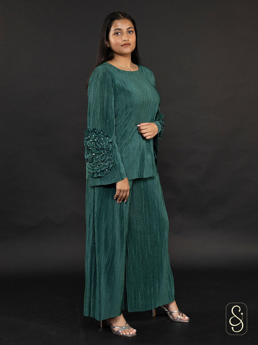 Woman wearing a green soft satin wrinkled co-ord set with ruffled sleeves.