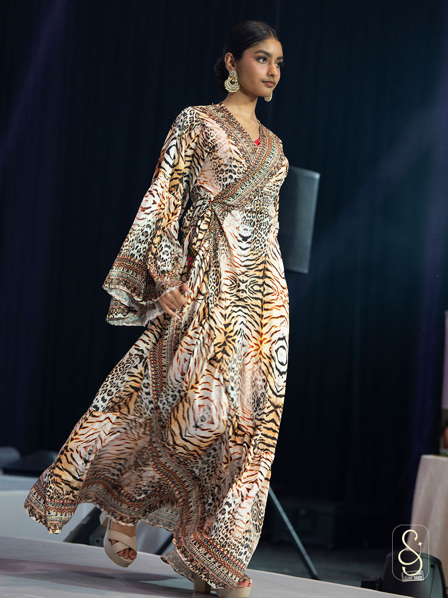 Model walking on a runway wearing a smooth viscose satin wrap dress.
