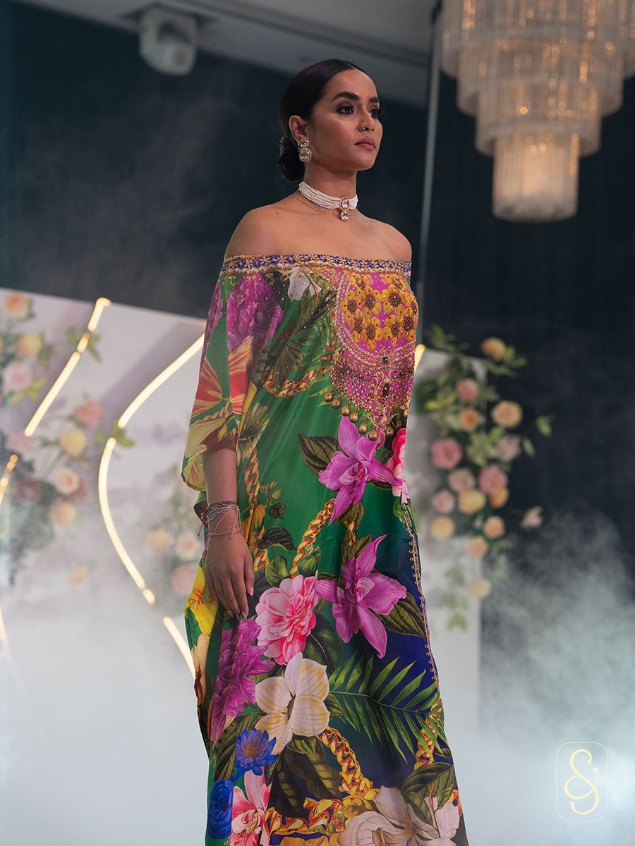 Woman in a off- shoulder colourful floral kaftan.