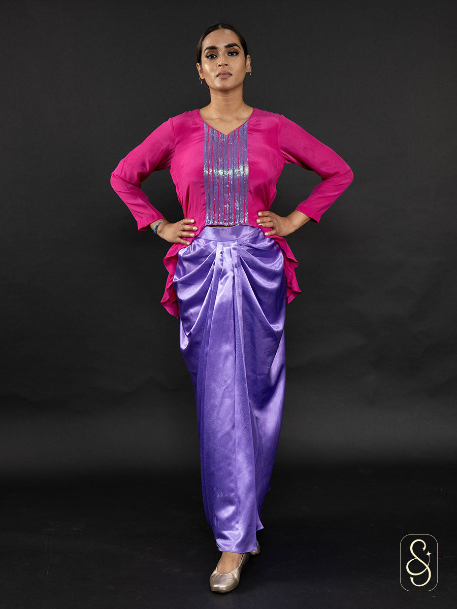 Woman wearing a satin skirt paired with a beautifully embroidered crepe top.