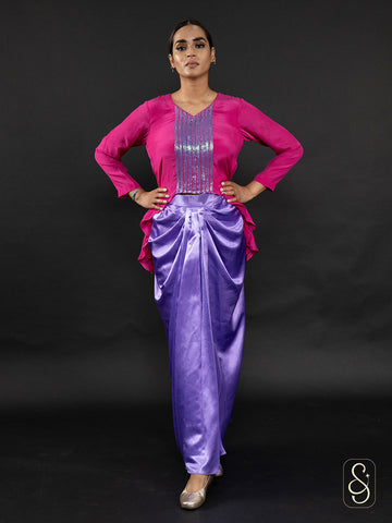 Woman wearing a satin skirt paired with a beautifully embroidered crepe top.